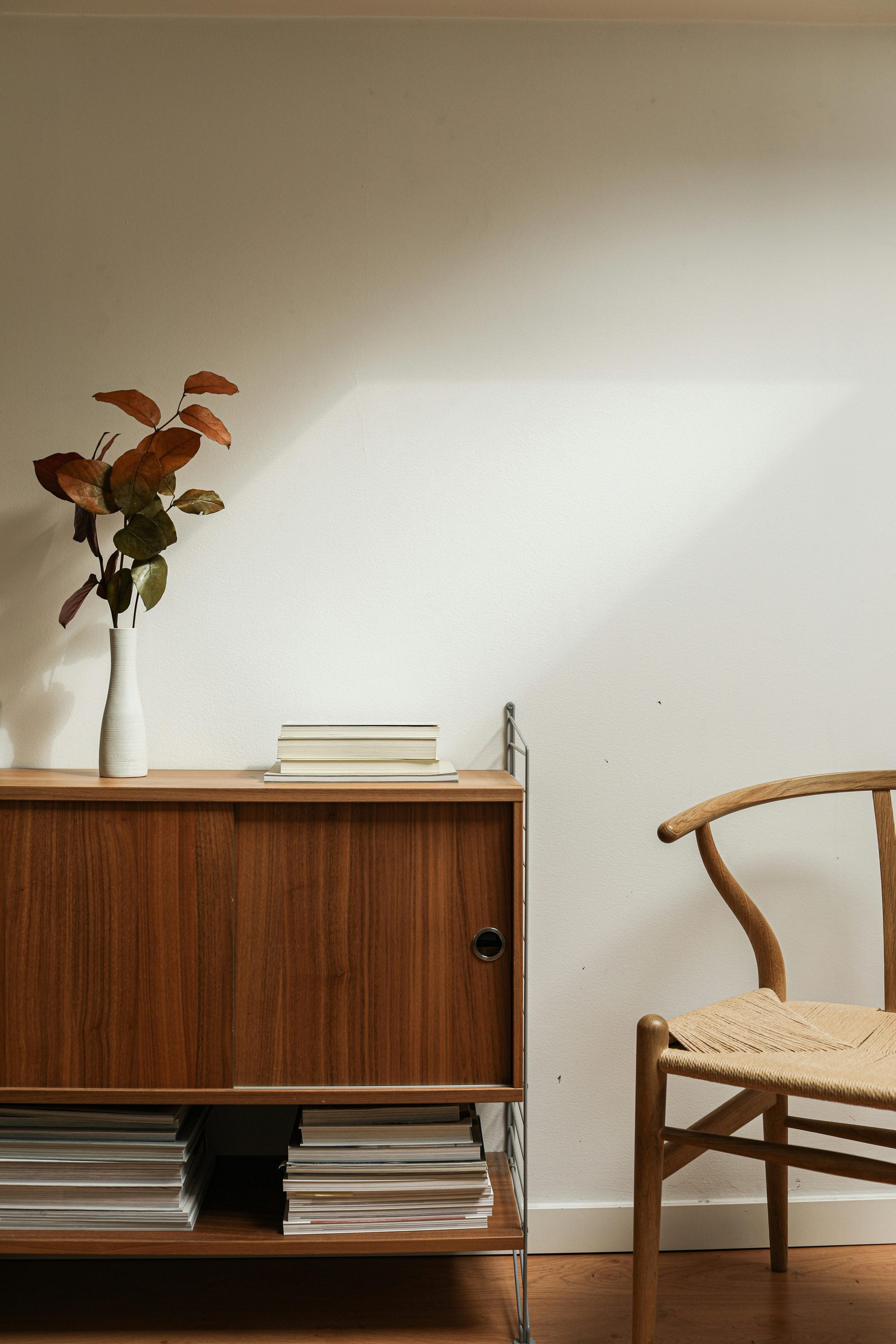 Warm Scandinavian interior with walnut credenza and Wishbone chair